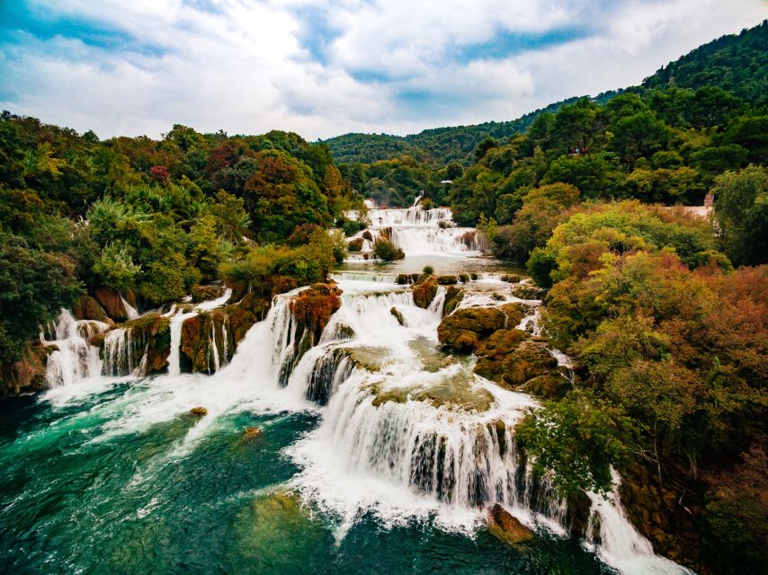 From Split & Trogir: Krka Waterfalls Day Tour with Boat Ride - First big stop: Krka National Park and the Skradinski Buk cascades
